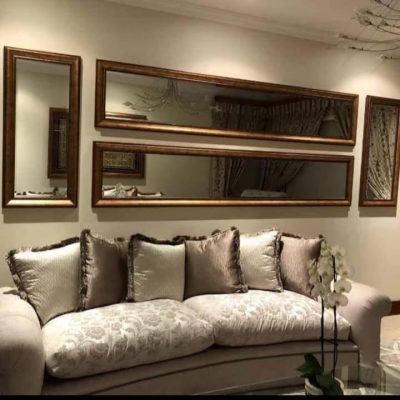 Bronze gold ornate framed mirror cluster arrangement above luxury lounge sofa — Mirror Art Gallery JHB