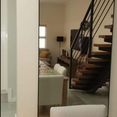 Floor-to-ceiling slim black framed mirror in open-plan lounge — Mirror Art Gallery