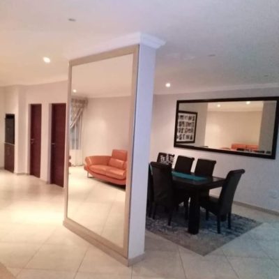 Floor-to-ceiling frameless mirror on lounge column — Mirror Art Gallery Johannesburg