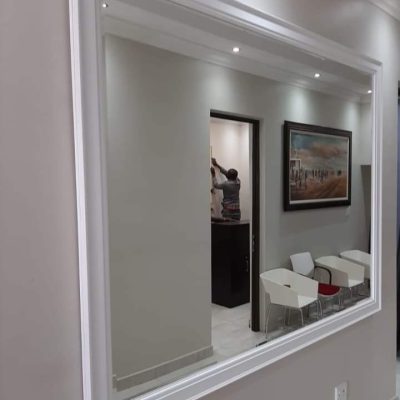 Large white framed mirror installed in commercial office space — Mirror Art Gallery Johannesburg