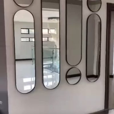 Bespoke mixed capsule and round mirror cluster feature wall installation — Mirror Art Gallery JHB